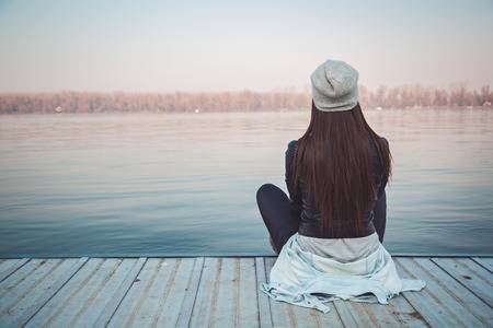 40838941-girl-sitting-on-pier-and-lookingat-the-river
